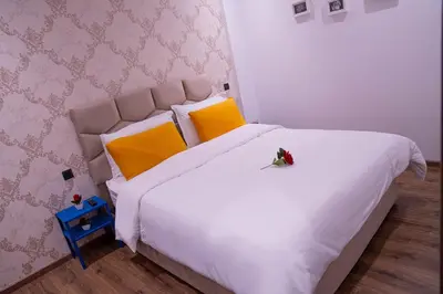 a bedroom with a large white bed with yellow pillows at R103- Comfy and Spatious 1 BR Apartment with Breathtaking City View - Belvédère in Casablanca