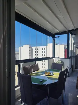 a dining room with a table and chairs and a large window at Apart 3ch 2sdb salon Centre ville in Casablanca