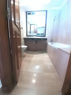 a bathroom with a toilet and a sink and a window at Appartement 380M BD El Massira Maarif in Casablanca