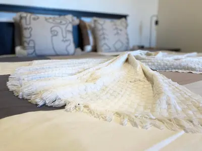 three beds with white sheets and pillows on them at Appartement Vue Panoramique sur la siesta plage WELCOME STAY in Mohammedia