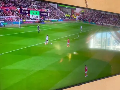 a tv screen showing a soccer game on a field at Quiet and spacious modern apartment near TGV station in Rabat