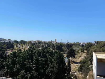 a view of a city with trees and a building at Quiet and spacious modern apartment near TGV station in Rabat