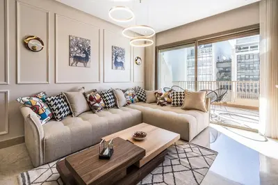 a living room with a couch and a table at Contemporary apartment in CFC Anfa in Casablanca
