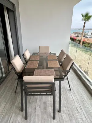 a dining room table and chairs with a view of the beach at Condo beach view in Casablanca in Casablanca