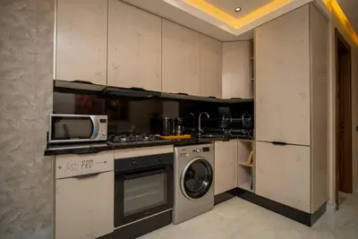 a kitchen with a microwave and a washer and dryer at Beautiful new studio with a Seaview 8 in Casablanca