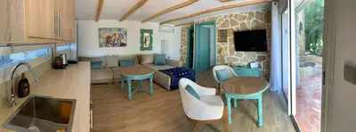 a kitchen and a living room with a table at Palmeraie 3 in Skhirat
