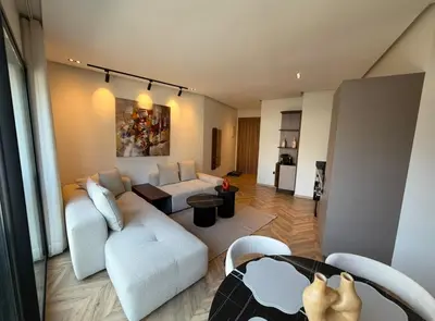 a living room with a couch and a table at Blue Skies Residence, Luxury Apartment, City Center in Casablanca