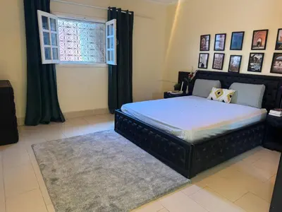 a bedroom with a large bed and a window at Villa luxueuse à Skhirat Rabat in Skhirat