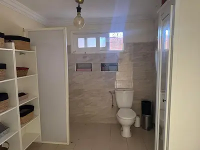 a bathroom with a white toilet in a room at Villa luxueuse à Skhirat Rabat in Skhirat