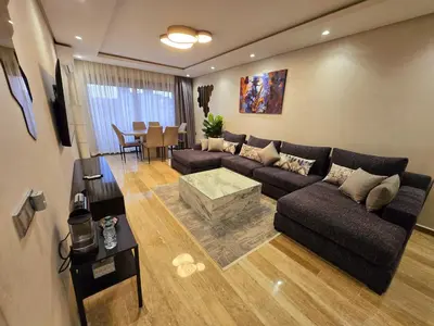a living room with a couch and a table at Luxe & Confort in Cité de Bournazel