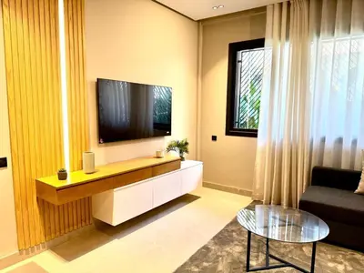 a living room with a large television and a couch at الدار بيضاء in Casablanca