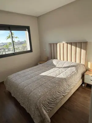 a bedroom with a large bed and two windows at Luxury 2 bedroom flat in Tamaris Dar Bouazza in Casablanca