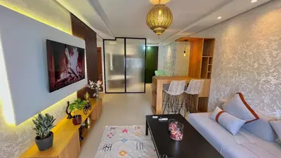 a living room with a couch and a table at N42 Luxe et Élégance avec Jacuzzi Privatif sur la Corniche Rabat Essabah in Rabat