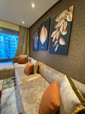 a living room with a couch and pictures on the wall at Marina Apartment Ocean View BY AppartAyla in Casablanca