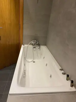 a white bath tub with a faucet in a bathroom at Marina Apartment Ocean View BY AppartAyla in Casablanca