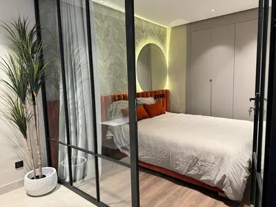a bedroom with a bed in a room with a mirror at المعاريف المارينا in Casablanca