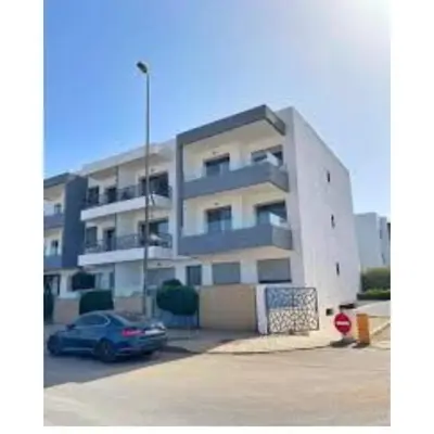 a building with a car parked in a parking lot at superbe appart a dar bouaza tamaris avec piscine in Casablanca