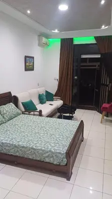 a bedroom with a bed and a couch at Studio confortable in Rabat