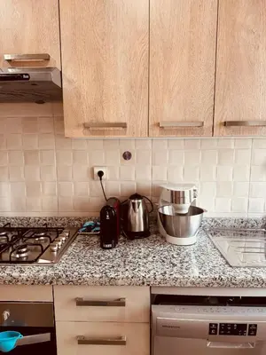 a kitchen with a counter top with a mixer and appliances at Modern Comfort with Moroccan Soul in Casablanca