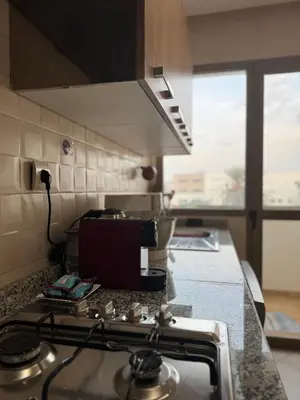 a kitchen with a stove top oven in a kitchen at Modern Comfort with Moroccan Soul in Casablanca
