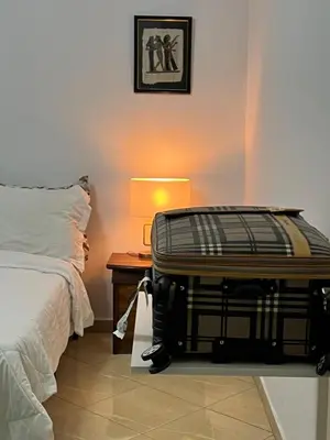 a bedroom with a suitcase sitting on the floor next to a bed at Private room 2 in Casablanca