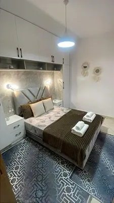 a bedroom with a large bed with two towels on it at Blue Beach & Sunny Life in Skhirate in Skhirat