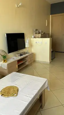 a living room with a television and a refrigerator at Appartement skhirat in Skhirat