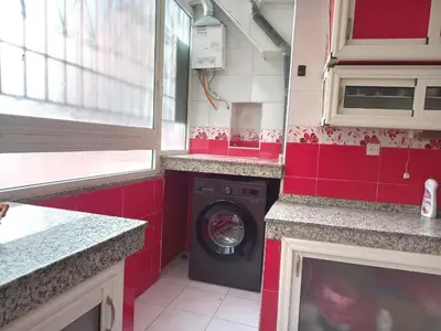 a washing machine in a small kitchen with red tiles at Hyatt Residence Casa Voyageur in Casablanca