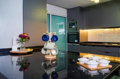 a kitchen with blue bowls and utensils on a counter at Stylish apartment - March 2 in Casablanca