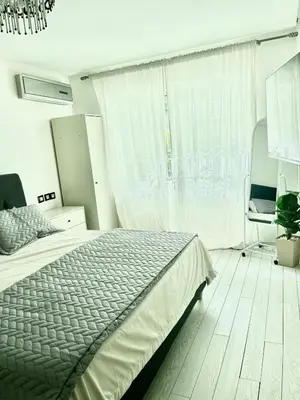 a bedroom with a bed and a large window at Stylish apartment - March 2 in Casablanca