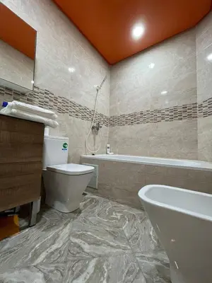 a bathroom with a toilet and a sink and a tub at Yalla Morocco in Temara