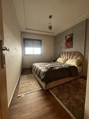 a bedroom with a large bed and a window at Charmant studio in Casablanca
