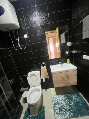a bathroom with a toilet and a sink and a mirror at Charmant studio in Casablanca