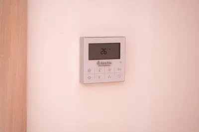 an electronic clock on a white wall at Premium Stay - Lux Housing Bourgogne in Casablanca