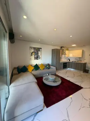 a living room with a couch and a table at Stunning sea-view apartment 20 in Casablanca