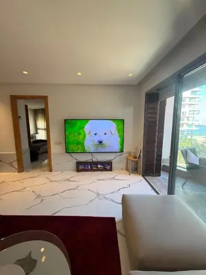 a living room with a large flat screen tv at Stunning sea-view apartment 20 in Casablanca