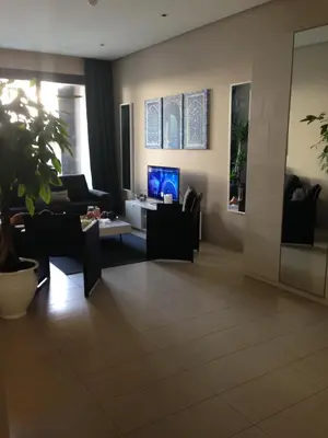 a living room with a couch and a tv at Unique in Casablanca