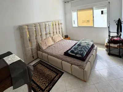 a living room with a couch and a window at Appartement Dadi in Rabat