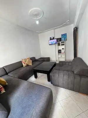 a living room with a couch and a table at Appartement Dadi in Rabat