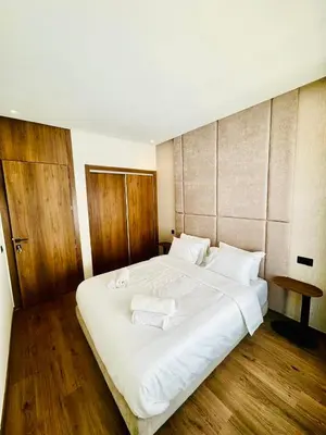 a bedroom with a large white bed with towels on it at studio tout confort, près de la corniche Casablanca in Casablanca