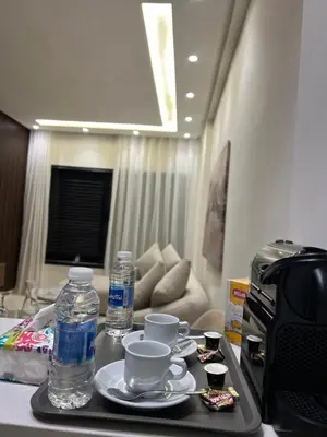 a tray with cups and water bottles on a table at studio tout confort, près de la corniche Casablanca in Casablanca