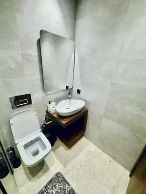 a bathroom with a toilet and a sink and a mirror at studio tout confort, près de la corniche Casablanca in Casablanca