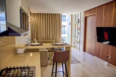 a kitchen and living room with a table and chairs at Les Princesse superbe Studio neuf moderne in Casablanca