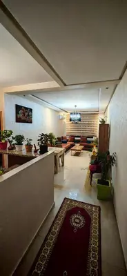a hallway with a living room with a rug at Luxury apartment in a prime location and quiet in Casablanca