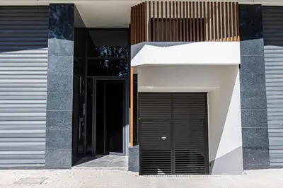 a building with a black door on the side of it at Acacia Studios in Casablanca