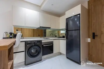 a kitchen with a black refrigerator and a dishwasher at Acacia Studios in Casablanca