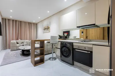 a kitchen with a washing machine in a room at Acacia Studios in Casablanca