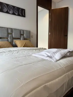 a white bed in a bedroom with a mirror at Appartement Casablanca in Casablanca