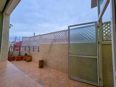 a glass door on a balcony with potted plants at Spacious & chic - 3 min from Casa City Finance 