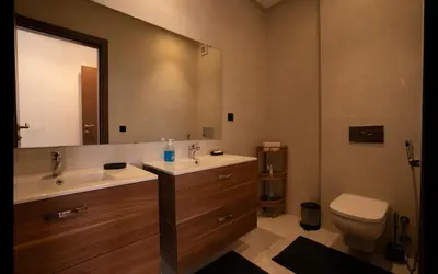 a bathroom with a sink and a toilet and a mirror at Appartement de haut standing au centre ville in Casablanca